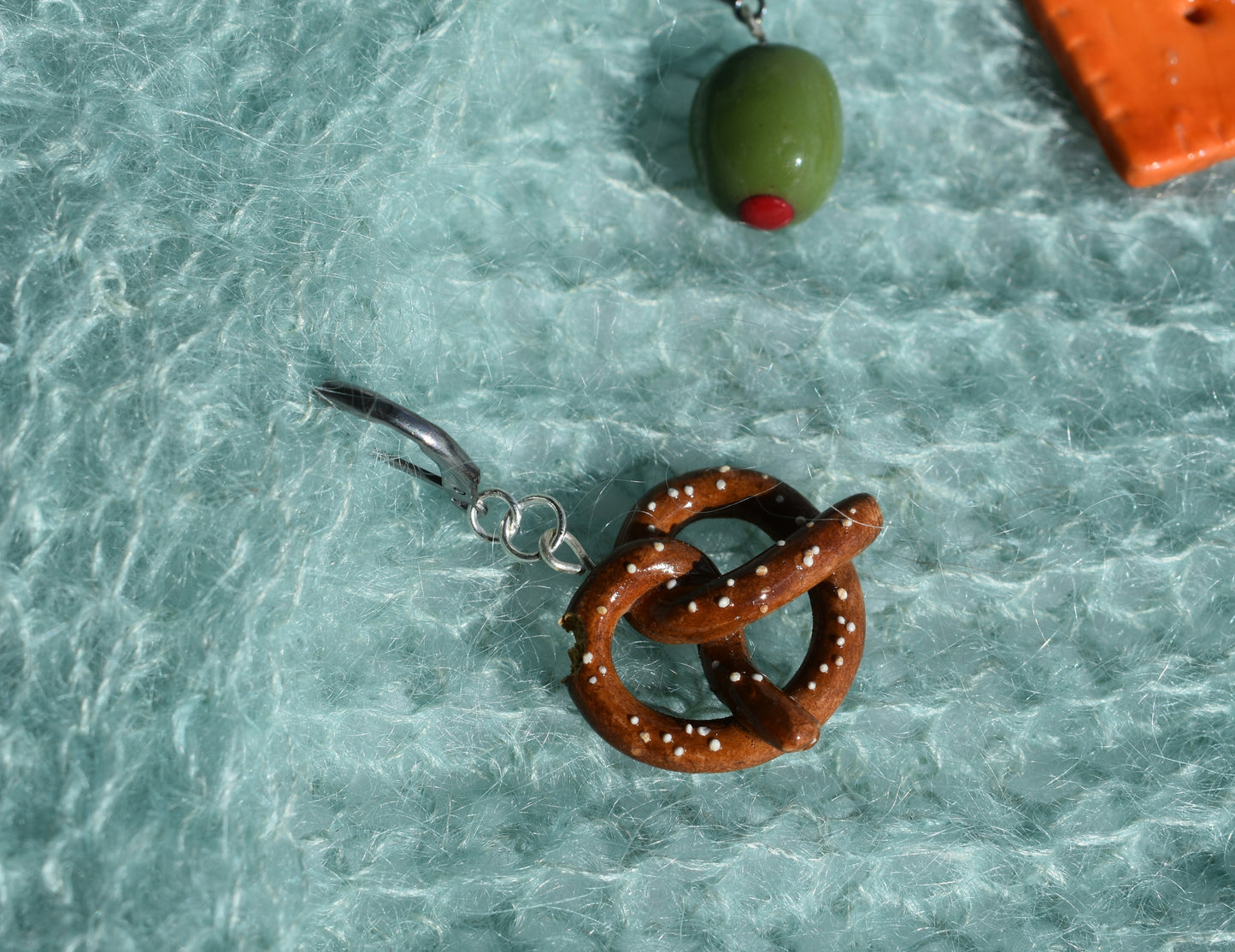 Pretzel-shaped fishing lure on a textured green surface