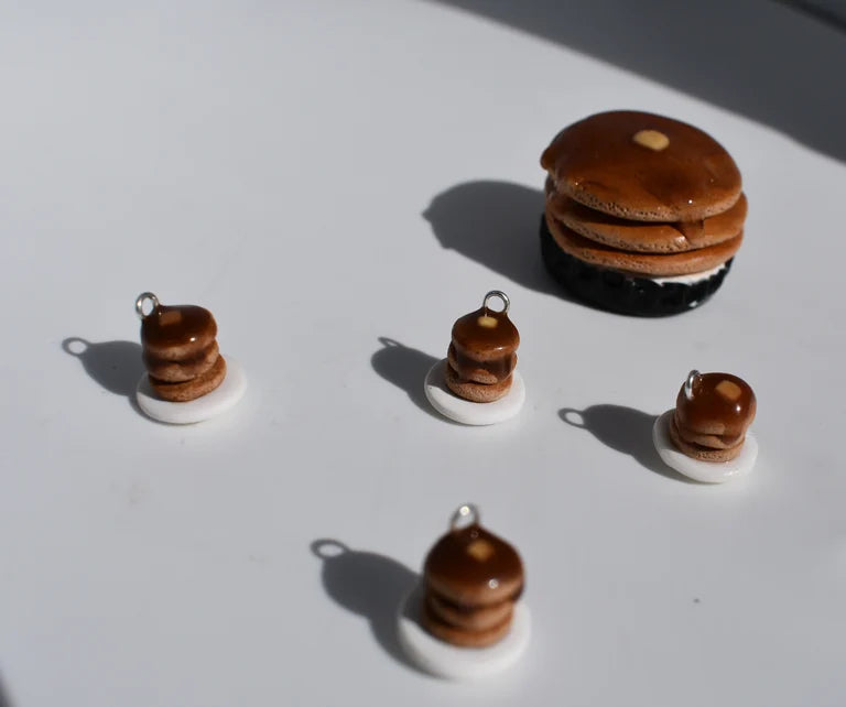 Set of miniature pancake charms on a white background