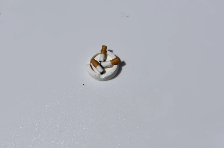 Small decorative item resembling a cigarette on a light gray background