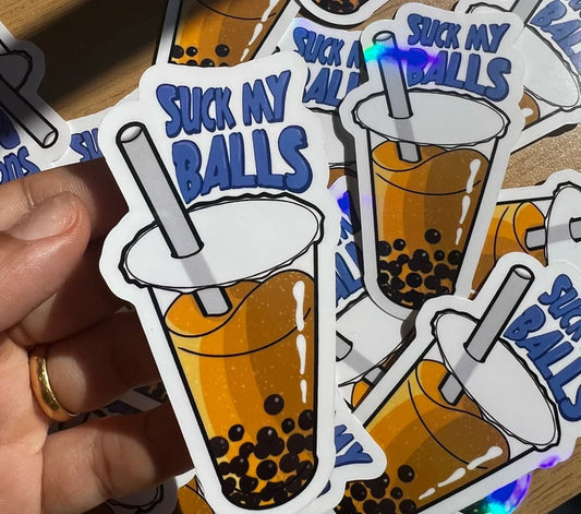 Sticker with bubble tea design and text 'Suck My Balls' held by a hand.