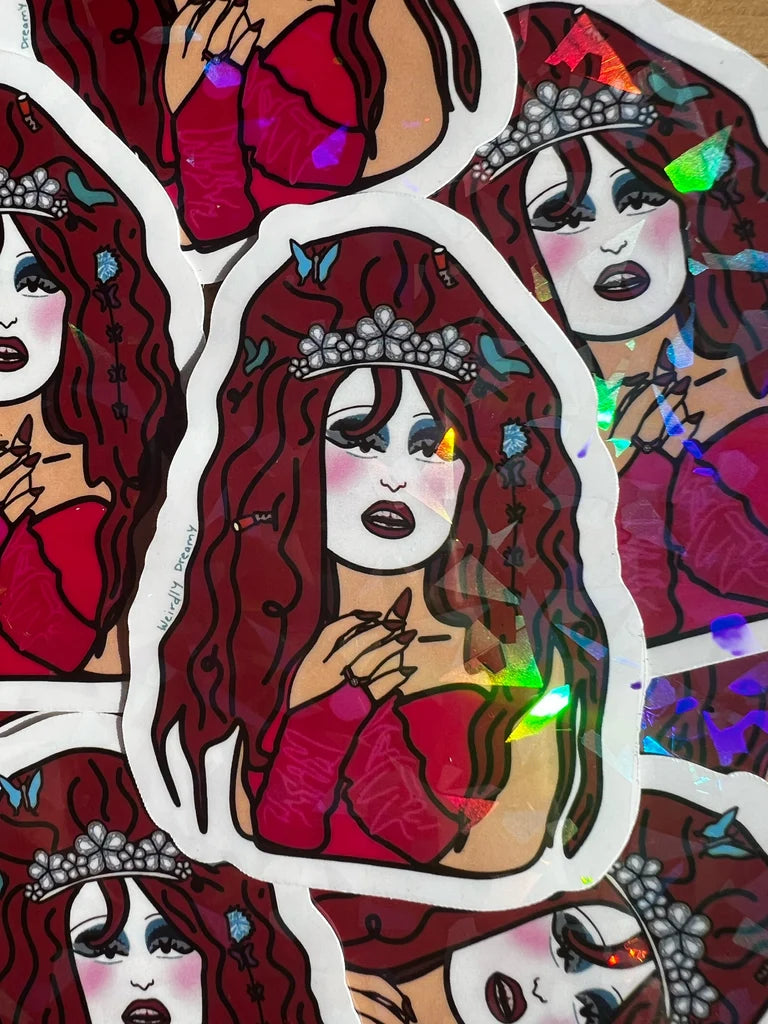 Sticker with a stylized illustration of a woman with red hair and a tiara, surrounded by other similar illustrations.