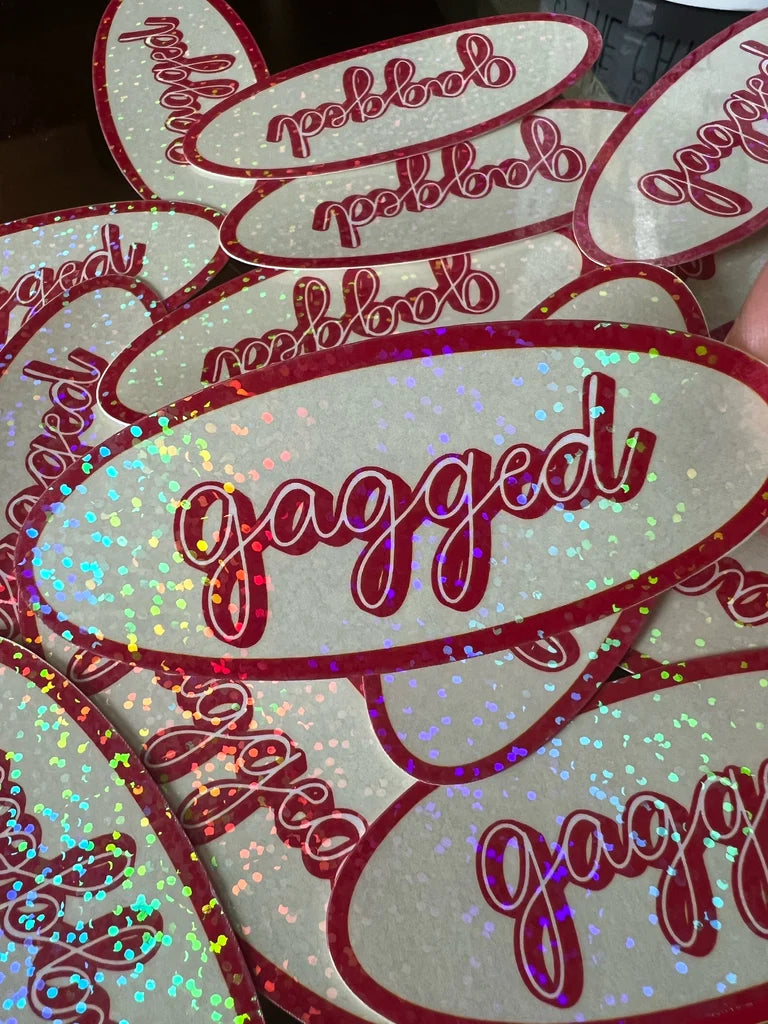 Glittery stickers with 'gagged' text on a white background