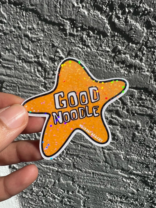 spongebob squarepants themed tar-shaped 'Good Noodle' sticker held against a textured gray background