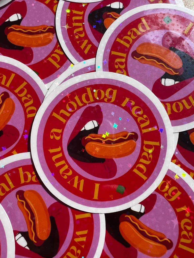 Stickers with a hotdog and text 'I want a hotdog real bad' on a pink background.