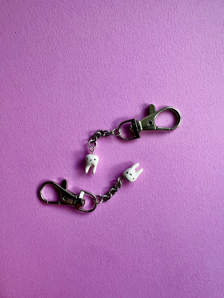 Keychain with cartoon character charms on a purple background