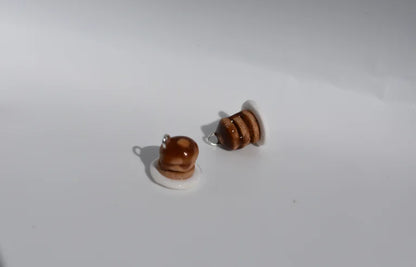 Pair of miniature pancake stack earrings on a white background