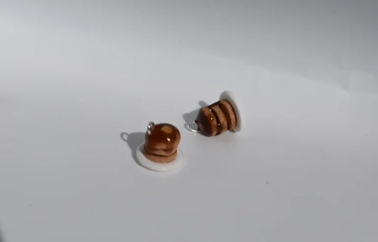 Pair of miniature pancake stack earrings on a white background