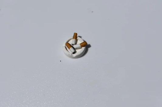 Small decorative item resembling a cigarette on a light gray background
