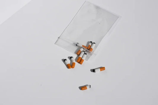 Small handmade miniature cigarettes on a white background