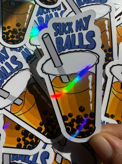 Sticker with a bubble tea design and text 'Suck My Balls' held by a hand.
