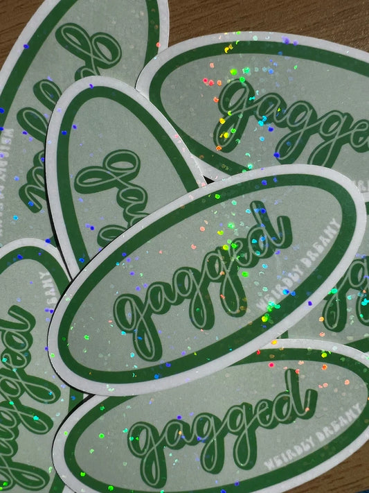 Stack of 'gagged' stickers with green text on a light gray background
