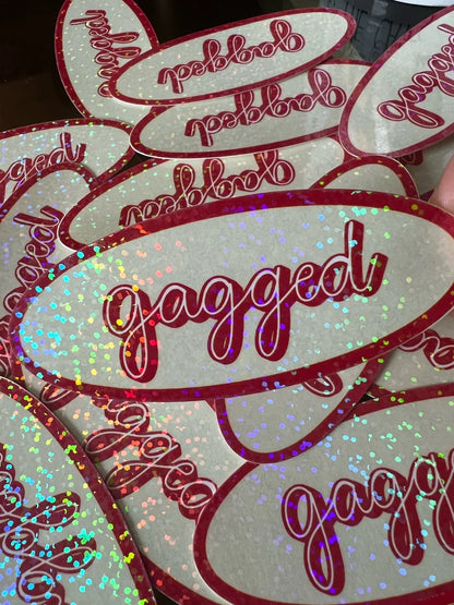 Glittery stickers with 'gagged' text on a white background