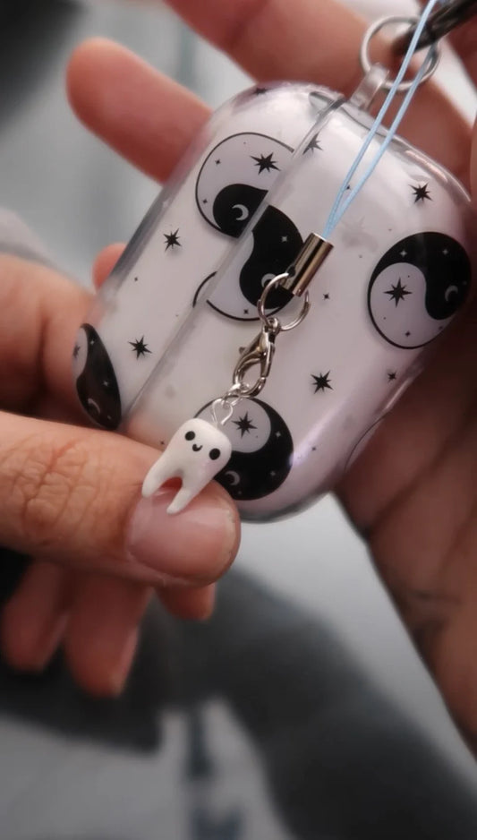 Small round container with black and white designs held by a hand