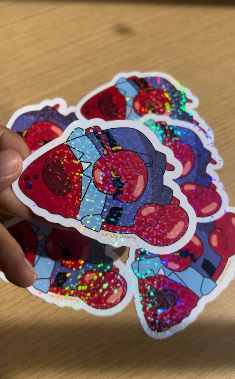 Colorful sticker with a cartoon character on a wooden surface