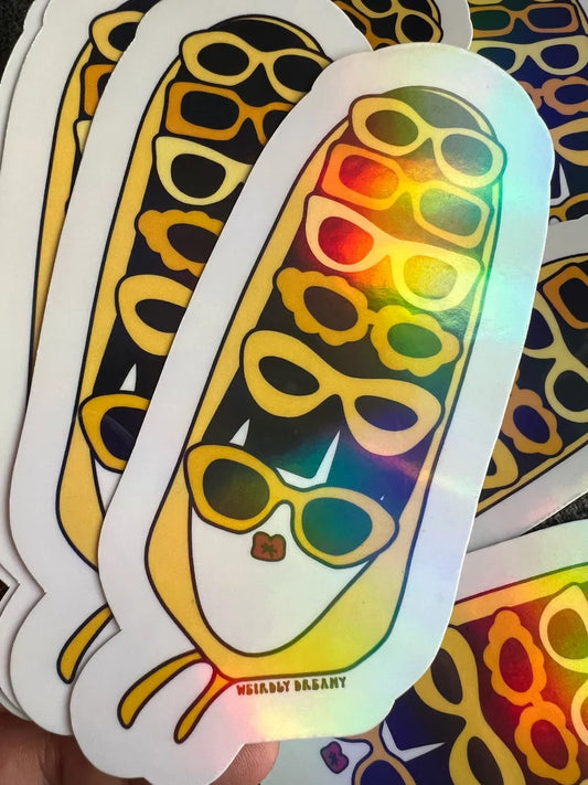 Holographic sticker of a face wearing sunglasses with a colorful gradient.
